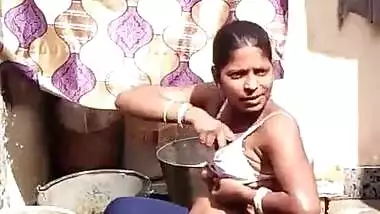 Desi aunty bathing outside